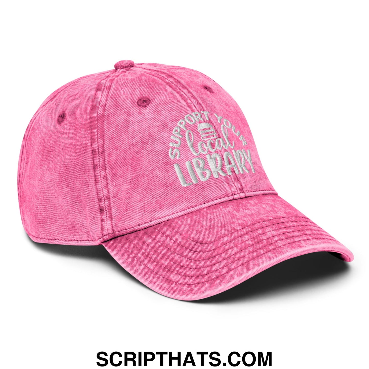 A faded pink unstructured denim dad hat with white embroidered text support your local library