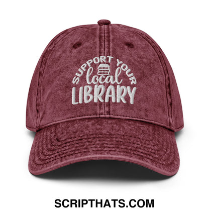 Maroon distressed cotton baseball cap with white embroidered support your local library text and book icon