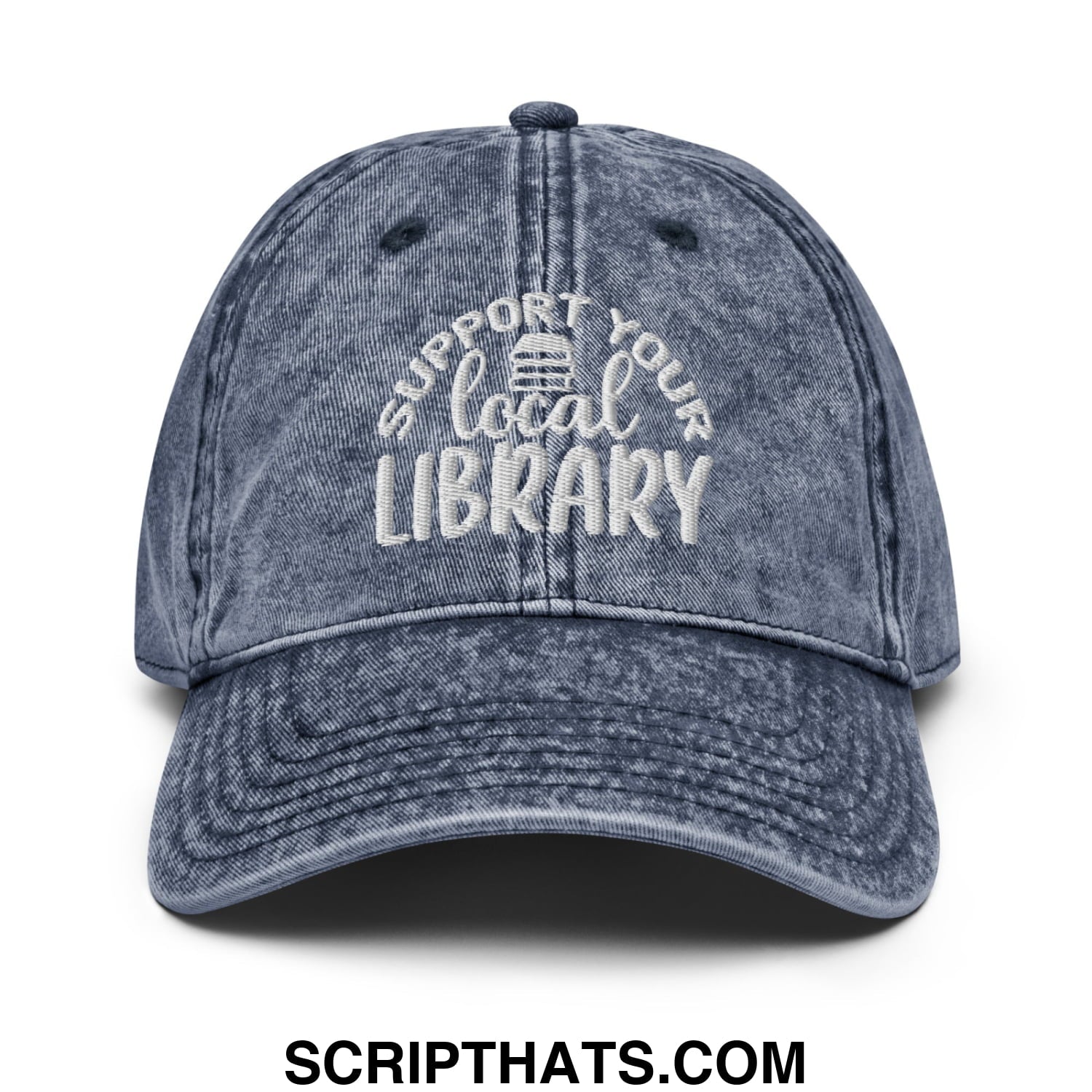 A faded blue denim dad hat with white embroidered support your local library text and a small library icon