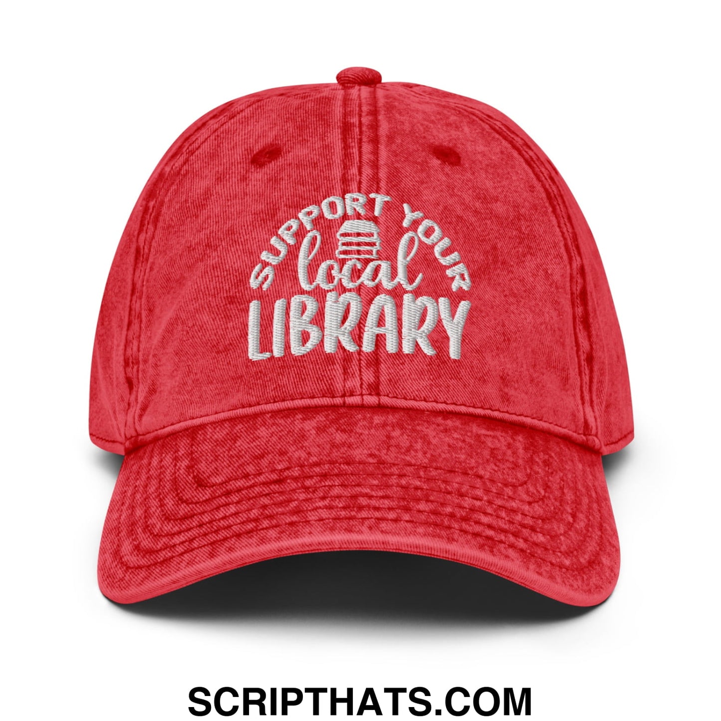 Red distressed cotton dad hat with white embroidered support your local library text and small book icon above local