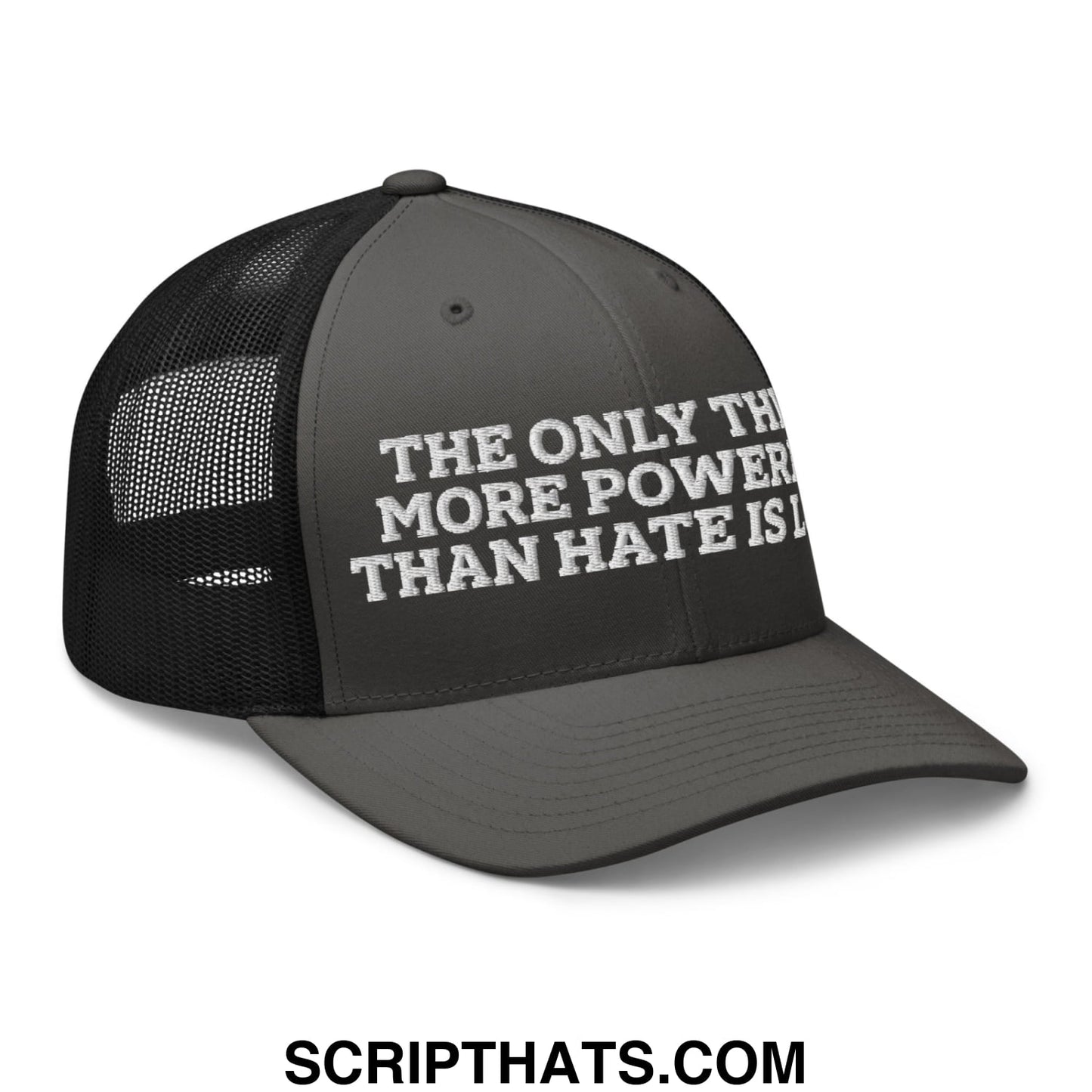 Black mesh trucker hat with white embroidered text saying the only thing more powerful than hate is love