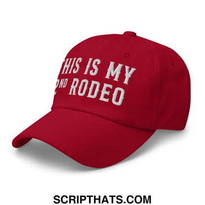 Red unstructured dad hat with white embroidered text reading this is my 2nd rodeo in a casual style