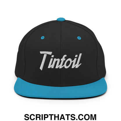 Black snapback cap with teal flat bill brim and silver tinfoil script embroidery on front panel