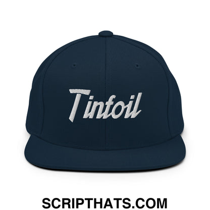 Dark navy blue snapback hat with white embroidered tinfoil sports script logo and flat bill brim design