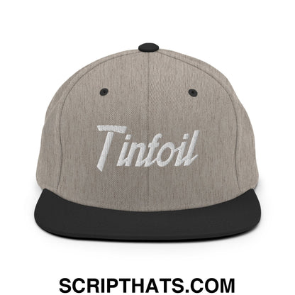Gray heather snapback cap with black brim and embroidered white tinfoil logo in sports script design