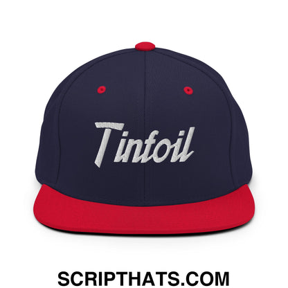 Navy blue snapback hat with red flat bill brim and white embroidered tinfoil sports script logo