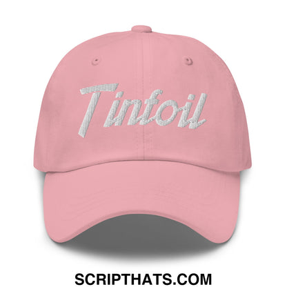 A soft pink unstructured dad hat with tintfoil embroidered in shimmering silver metallic thread on the front