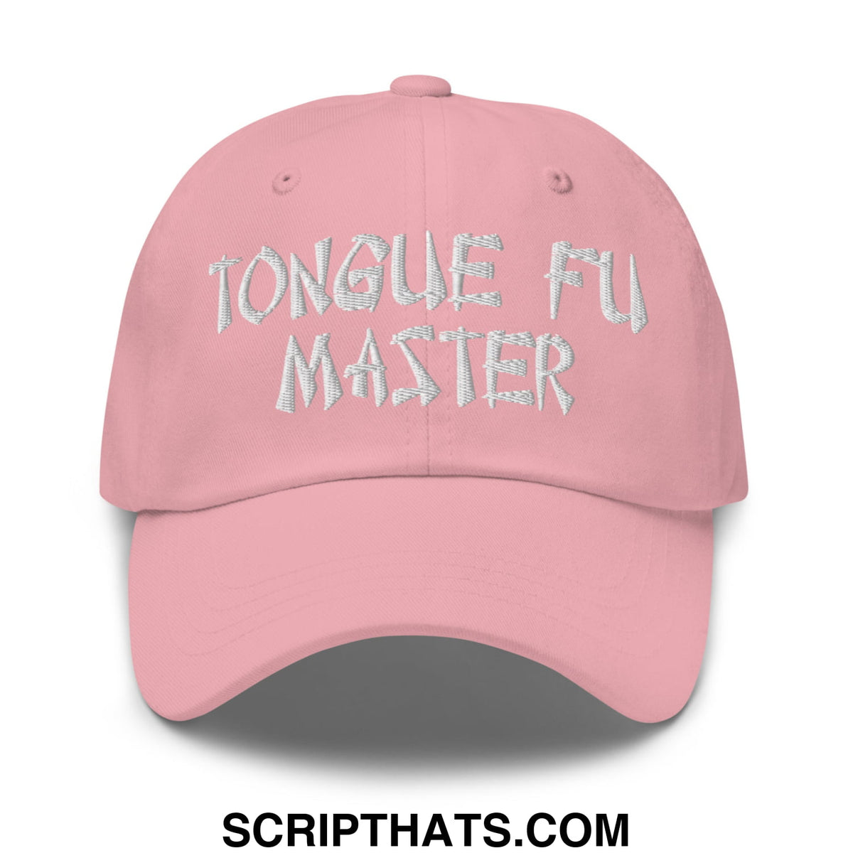 A soft pink unstructured dad hat with tongue fu master embroidered in textured silver thread on front