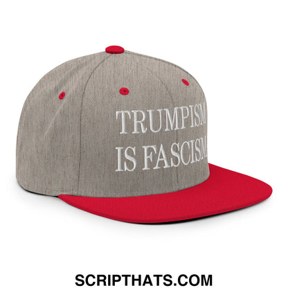 Gray and red snapback hat with white embroidered text reading trumpism is fascism on flat bill brim