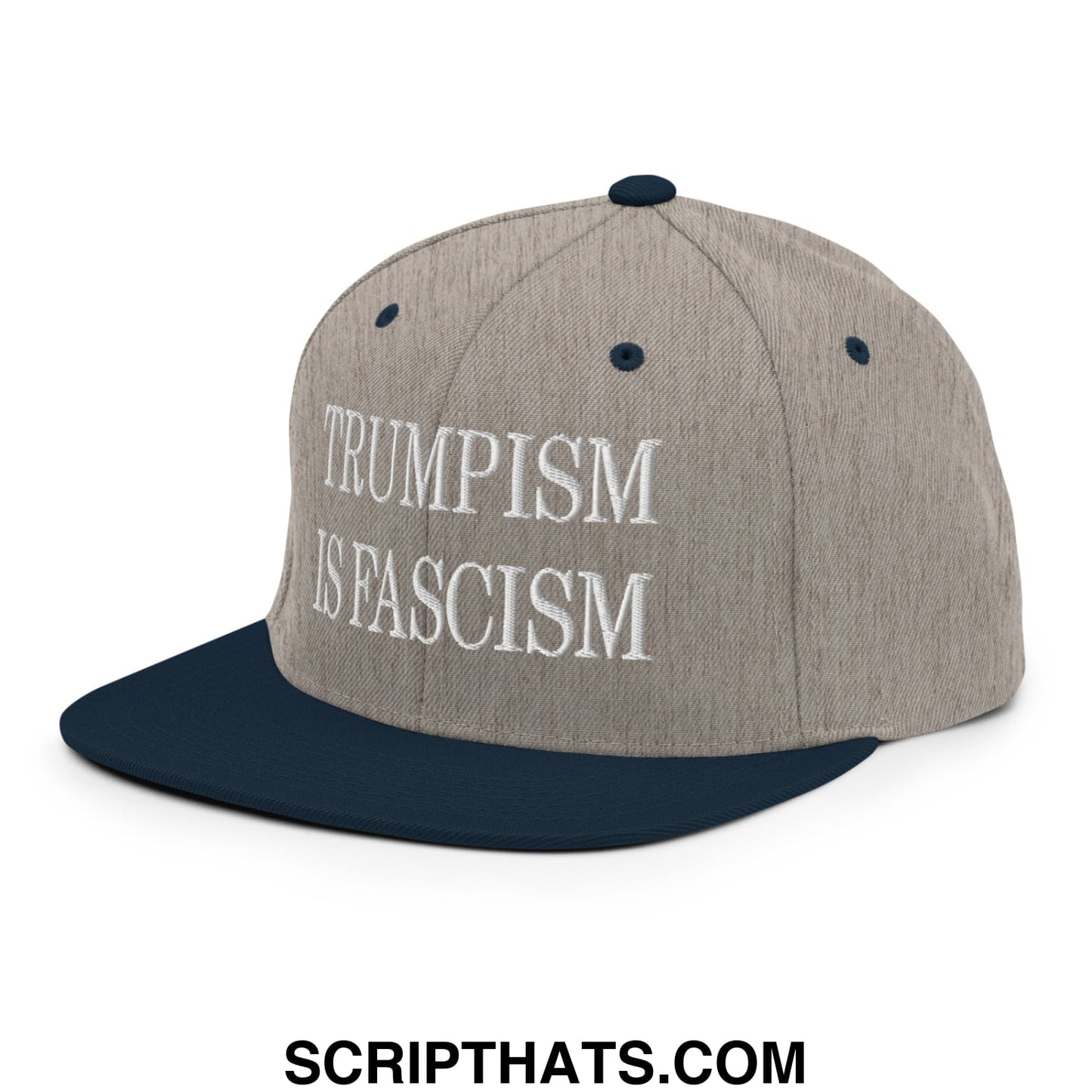 A gray and navy blue snapback hat with white embroidered text reading trumpism is fascism on the front brim