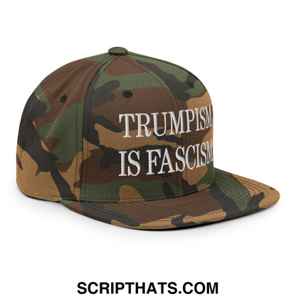 A camouflage-patterned snapback hat with white embroidered text reading trumpism is fascism on the front panel