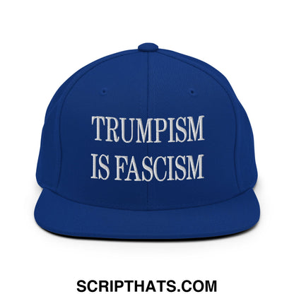 Royal blue snapback cap with white embroidered text trumpism is fascism and flat bill brim design