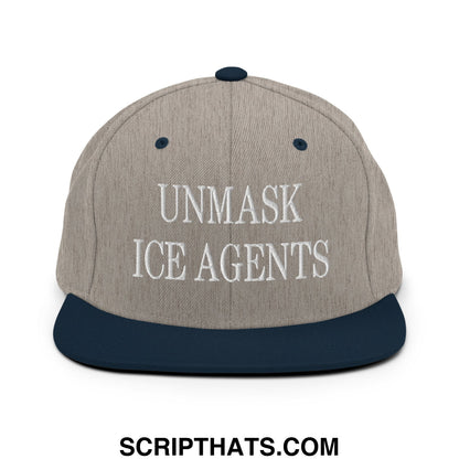 A gray and navy blue snapback hat with white embroidered unmask ice agents text on the front flat bill brim