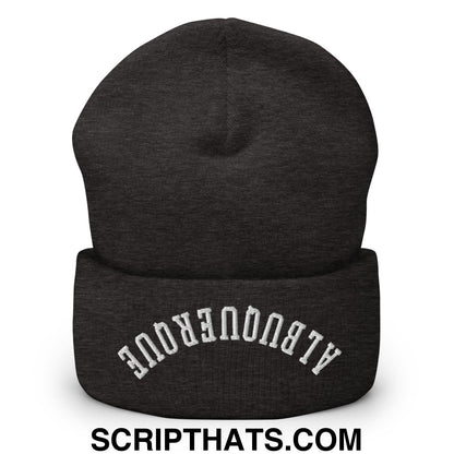 A dark heather gray knit cuffed beanie with white embroidered albuquerque upside down on the front
