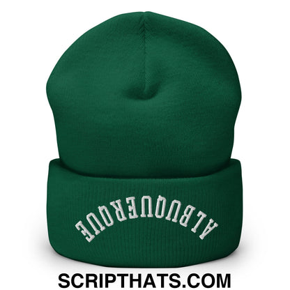 A dark green knit cuffed beanie with upside down albuquerque embroidered in white on the folded cuff