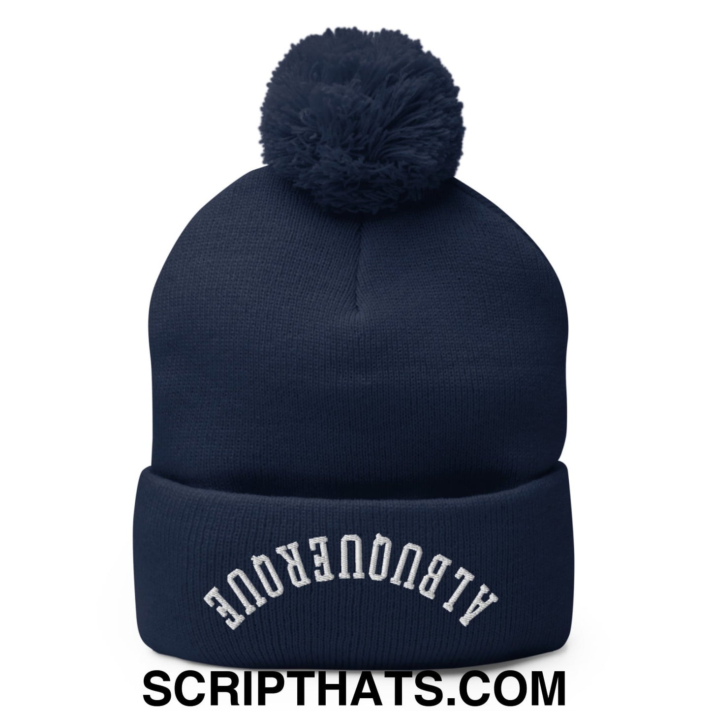 Navy blue knit beanie with a fluffy pom pom and white airbronque embroidery on the folded brim