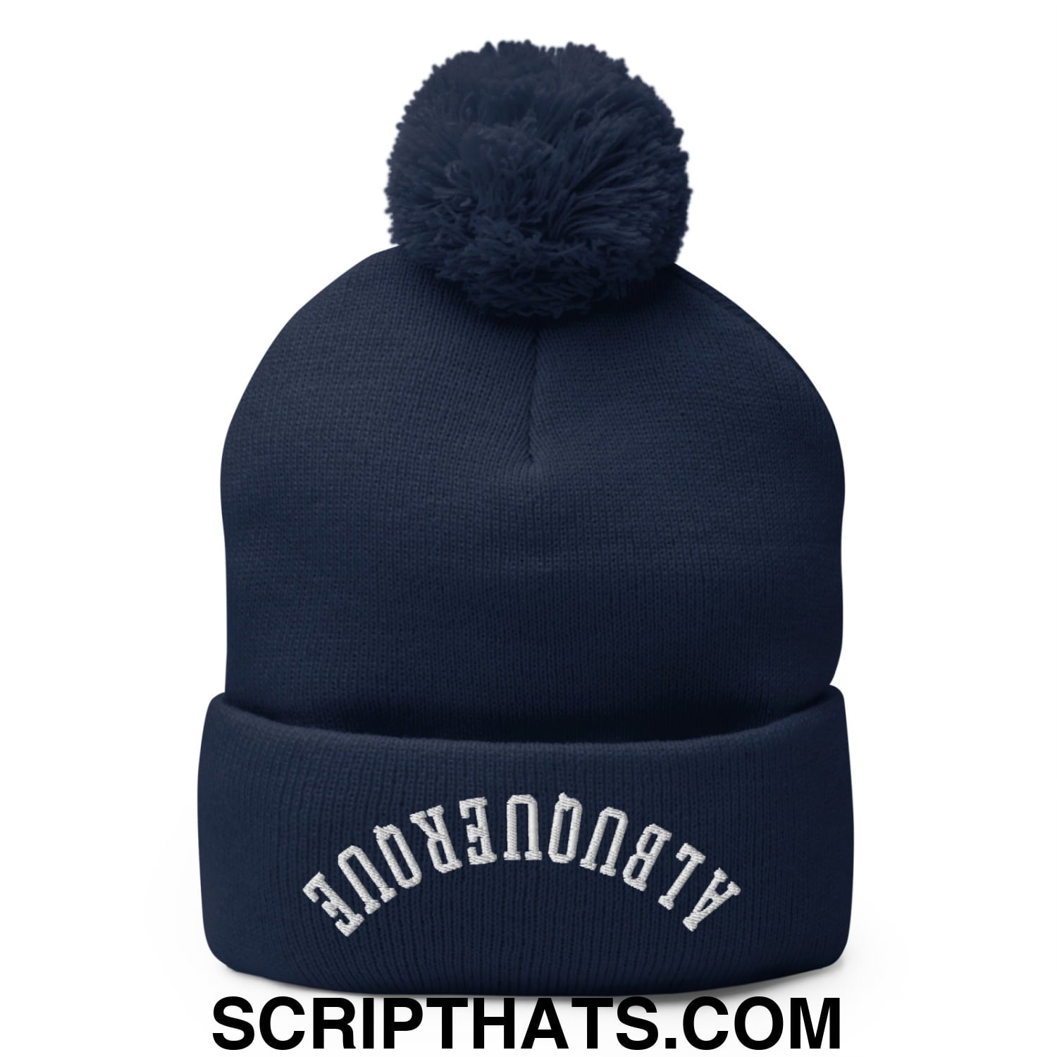 Navy blue knit beanie with a fluffy pom pom and white airbronque embroidery on the folded brim