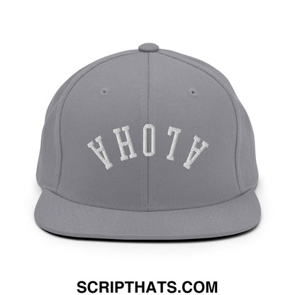 Gray snapback cap with white embroidered ahoty lettering in an arched design upside down aloha flat bill brim hat