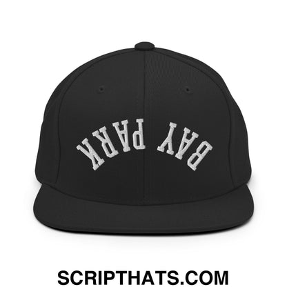 Black snapback cap with white embroidered bay park lettering in a classic arched design and flat bill brim