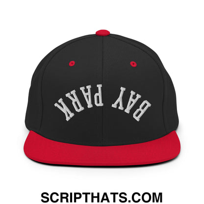 Black and red snapback hat with white embroidered bay park lettering and a flat bill brim in a sporty style
