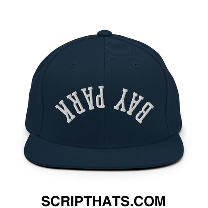 Navy blue snapback hat with white arched bay park embroidery and flat bill brim for casual wear