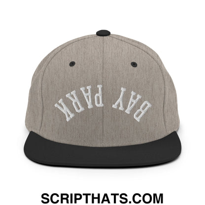Gray and black snapback hat with white embroidered bay park lettering and flat bill brim in upside down design