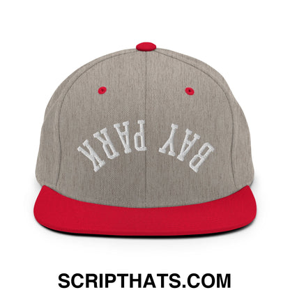 Gray and red snapback cap with white embroidered bay park lettering and flat bill brim in upside down design