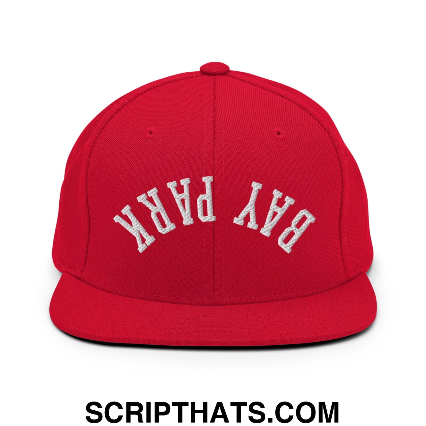 Red snapback cap with white embroidered bay park lettering and flat bill brim in a streetwear style design