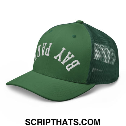 Green mesh trucker hat with white embroidered bay park lettering featuring upside down design