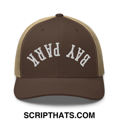 Brown and tan mesh trucker hat with white embroidered bay park lettering featuring upside down design