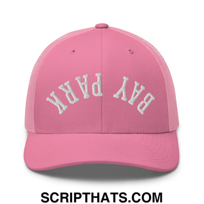 Pink mesh trucker hat with white embroidered bay park lettering featuring upside down design
