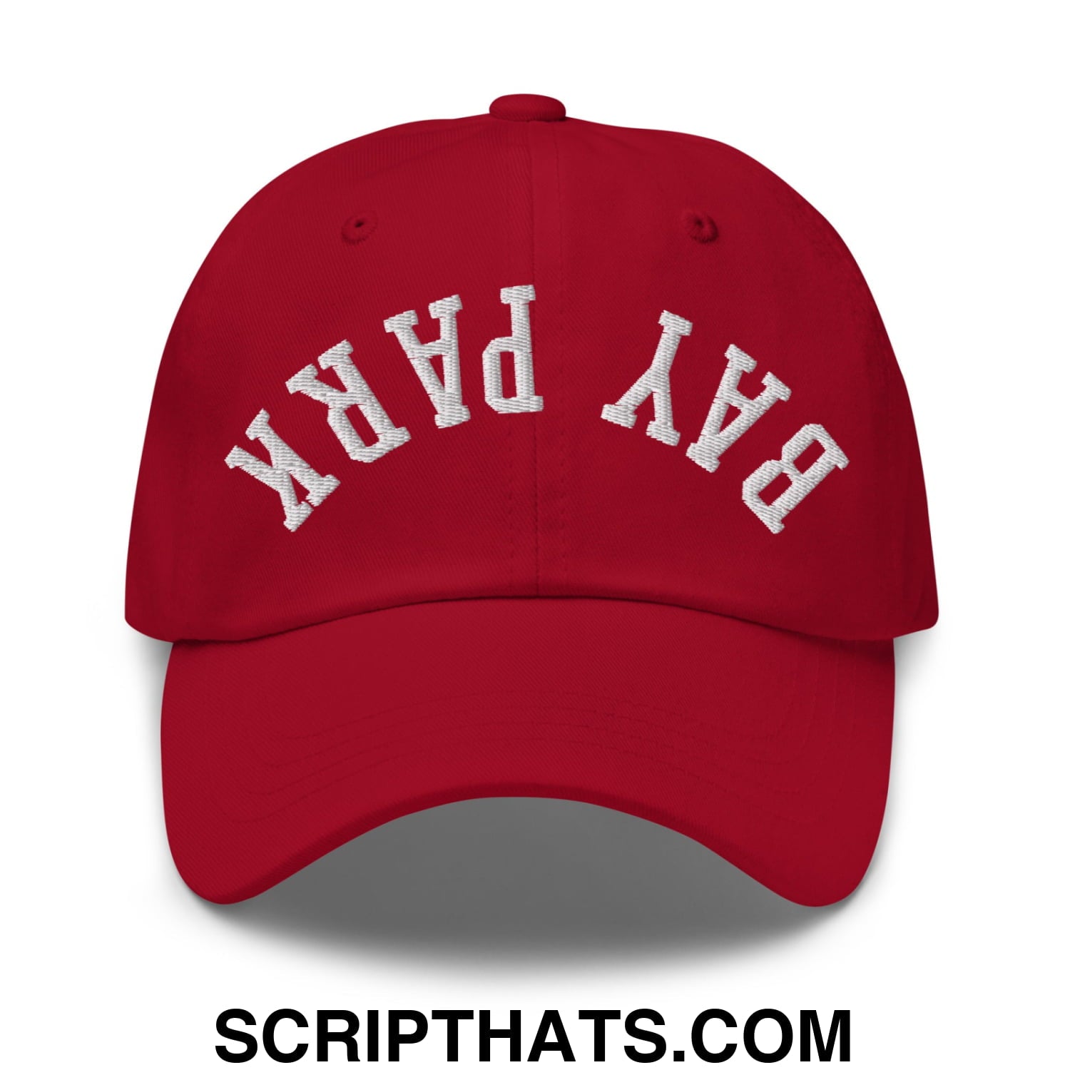 Red unstructured dad hat with white embroidered bay park lettering in an arched design, upside down style