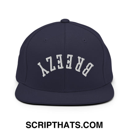 Navy blue snapback hat with white arched breezy embroidery and flat bill brim for casual wear