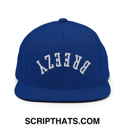 Royal blue snapback cap with upside down breezy embroidered flat bill brim in white stitching