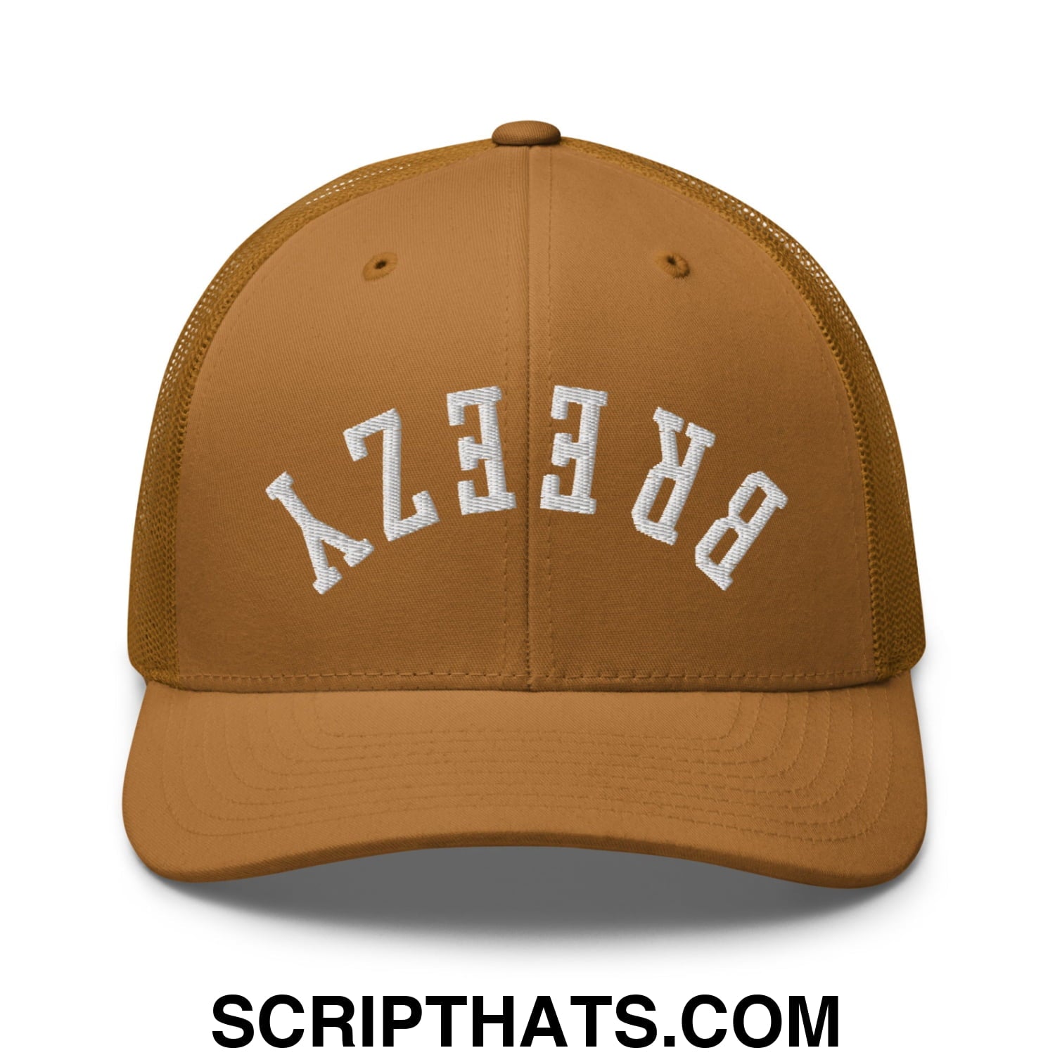 A tan mesh trucker hat with white embroidered lettering reading breezy in an arched design