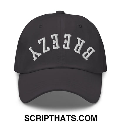 Black unstructured dad hat with white arched breezy embroidery featuring an upside down style design