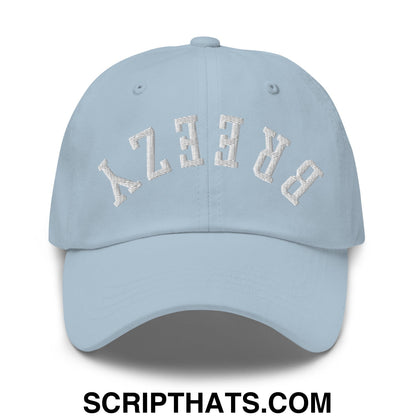 Light blue unstructured dad hat with white embroidered breezy lettering in an arched design called upside down breezy