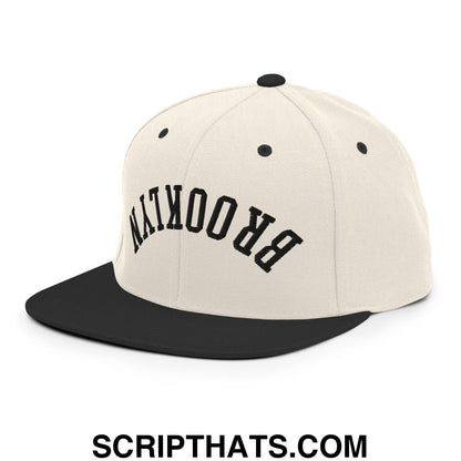 Beige and black snapback cap with brooklyn embroidered in bold black on the front flat bill brim hat