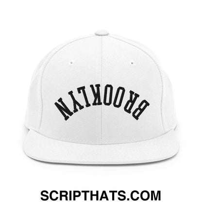 White snapback cap with black arched brooklyn lettering embroidered on flat bill brim for casual wear