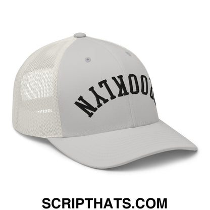 Gray mesh trucker hat with black arched brooklyn lettering embroidered on the front panel