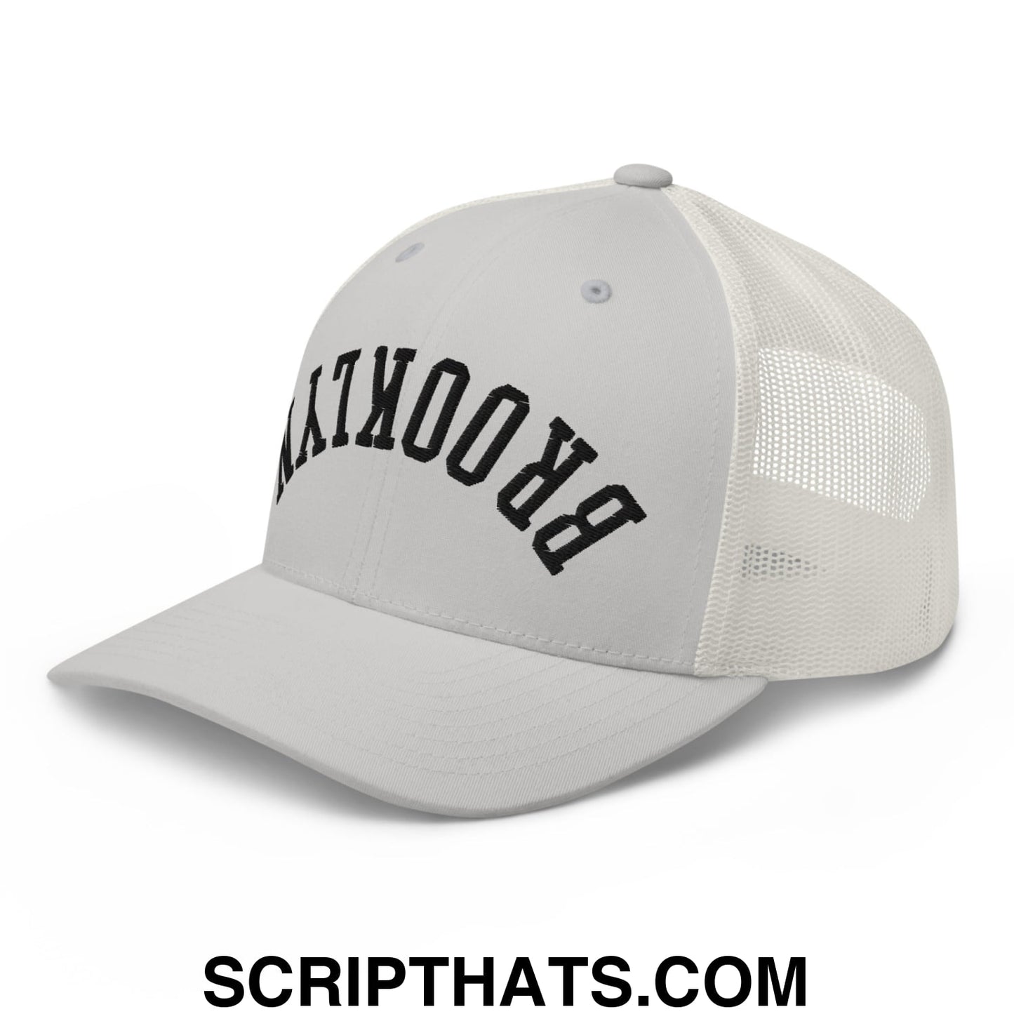 A light gray mesh trucker hat with black arched brooklyn embroidery on the front panel