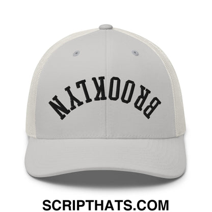 White mesh trucker hat with black arched brooklyn embroidery featuring upside down design