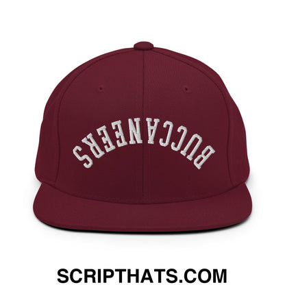 Maroon snapback cap with white embroidered upside down buccaneers arch design and flat bill brim
