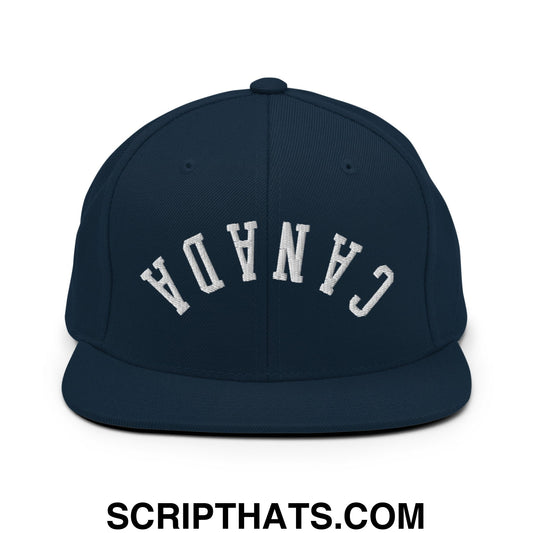 Navy blue snapback hat with white embroidered canada lettering and flat bill brim in an upside down design