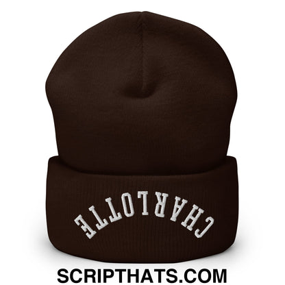 A dark brown knit cuffed beanie with upside down charlotte embroidered in white on the folded cuff