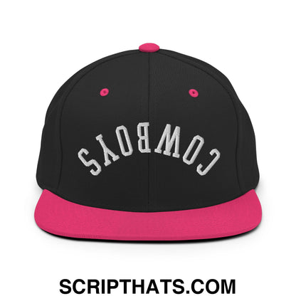 Black snapback cap with pink brim and button featuring white embroidered cowboys lettering flat bill brim design