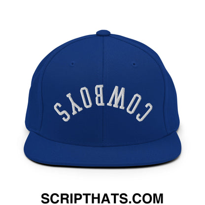 Royal blue snapback hat with white embroidered cowboys lettering and flat bill brim in upside down design