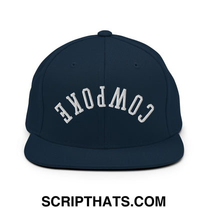 Navy blue snapback hat with white embroidered cowpoke lettering and flat bill brim in an arched design