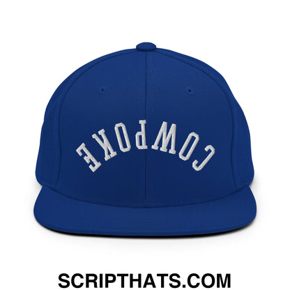 Royal blue snapback hat with white embroidered cowpoke lettering and flat bill brim in an arched design
