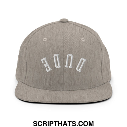 Gray heathered snapback cap with white embroidered dude lettering and flat bill brim in upside down design